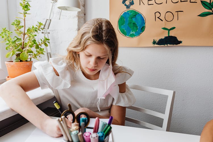 A Young Woman In White Dress Writing