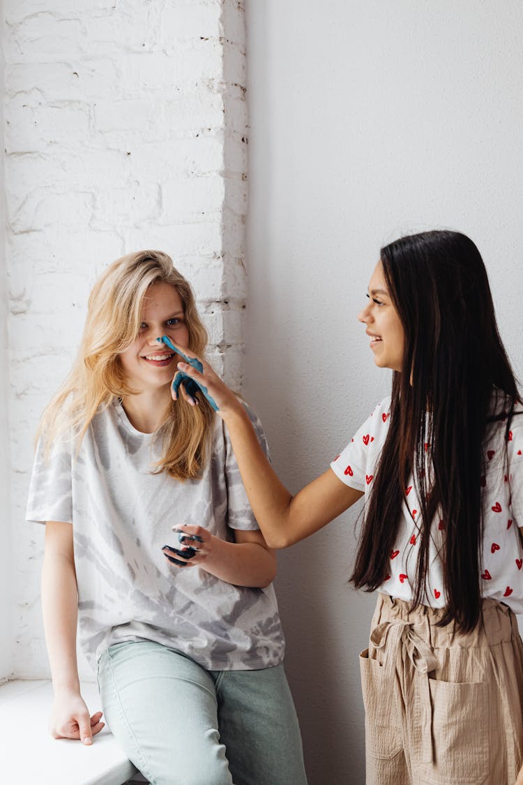 Young Women Having Paint Stain In Their Hands