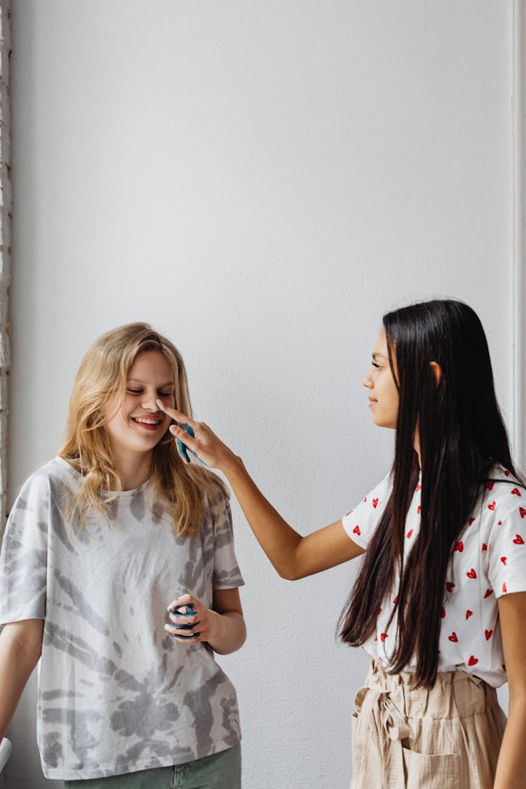 Woman Touching Woman's Nose