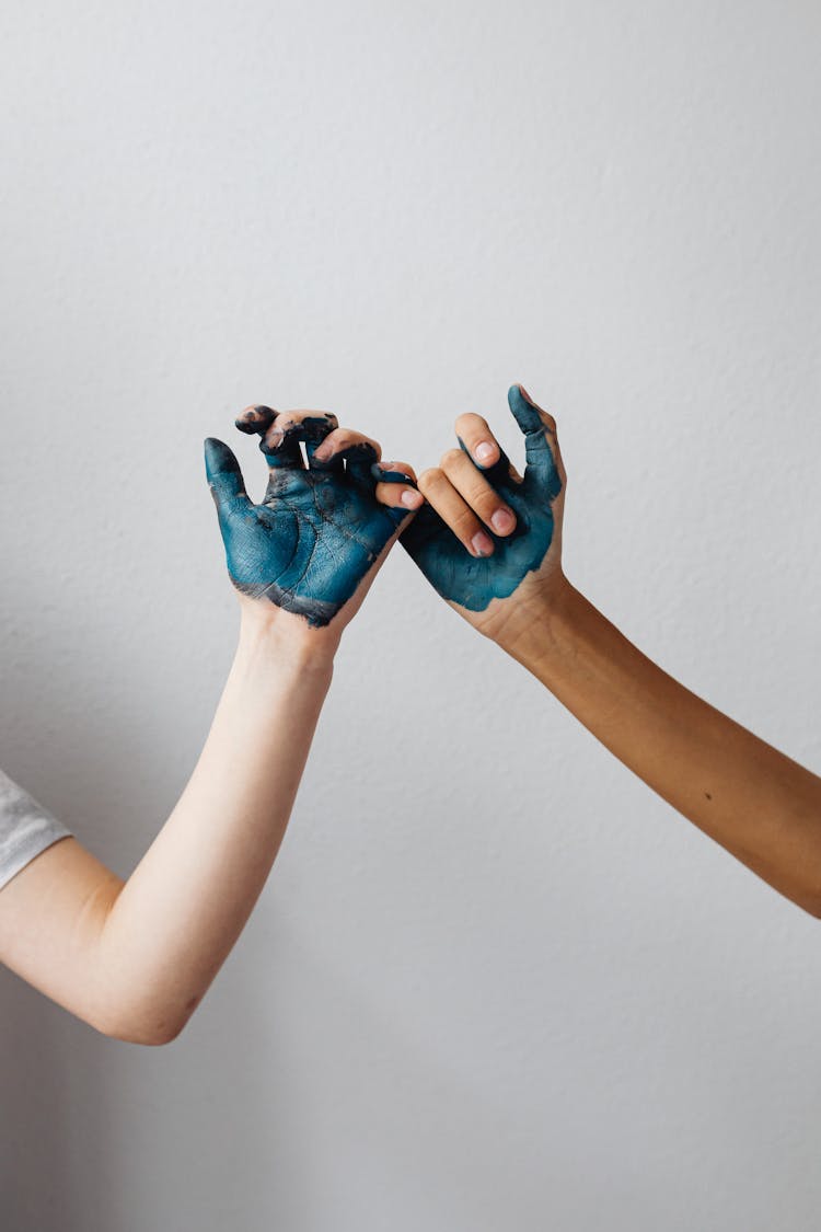 Person With Blue Paint On Palm