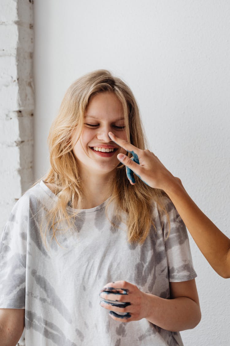 A Young Woman Getting A Paint In The Nose