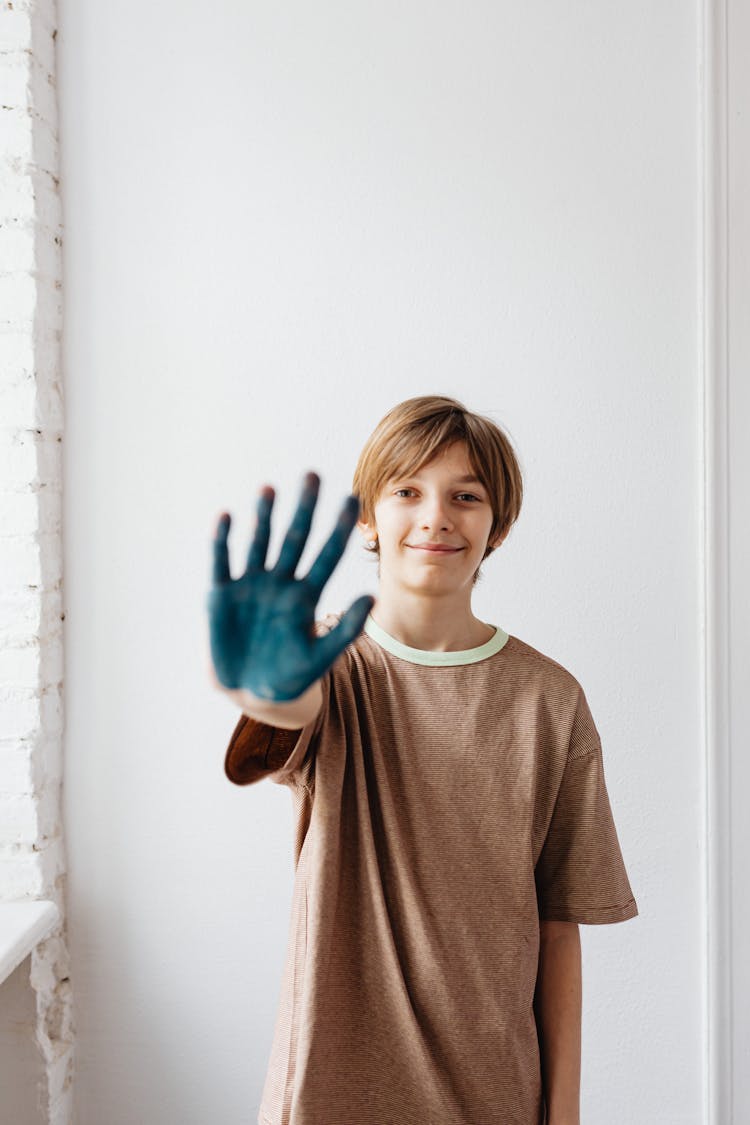 Photo Of A Boy With Blue Paint On His Hand