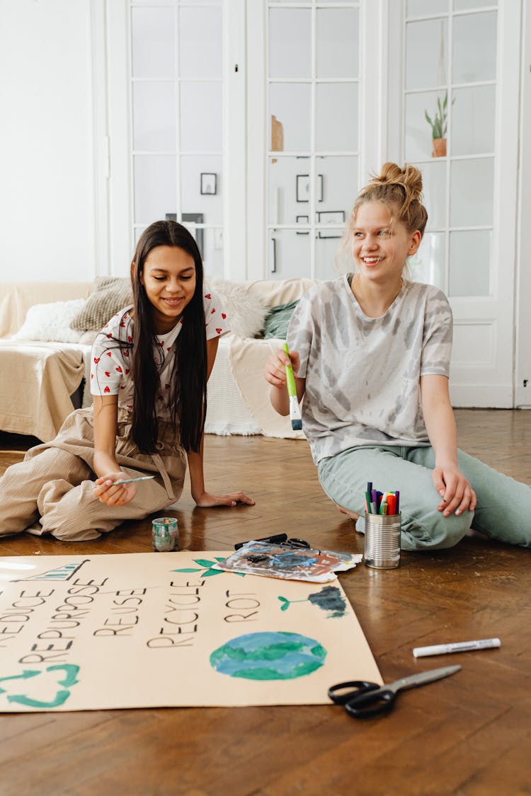 Smiling Girls Sitting And Painting