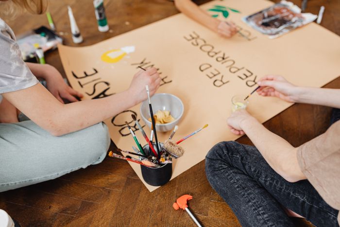 People collaborating on a hand-painted poster — photo by Kaboompics on Pexels