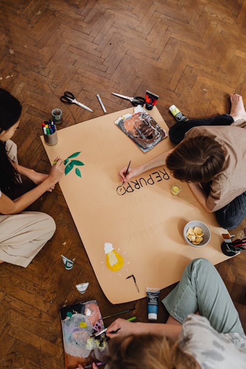 Friends Painting on Brown Paper