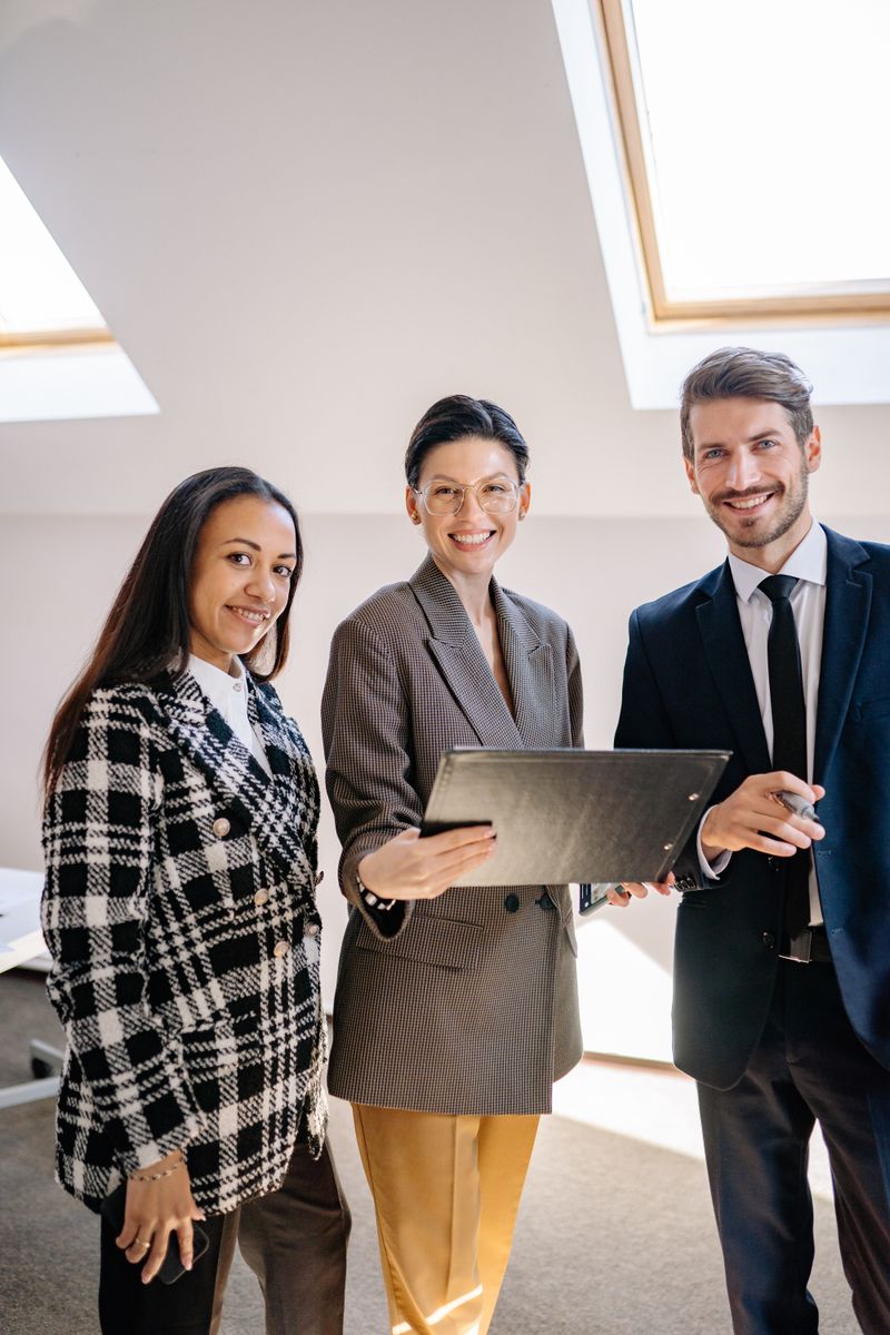 Professional business team smiling together in an office environment.