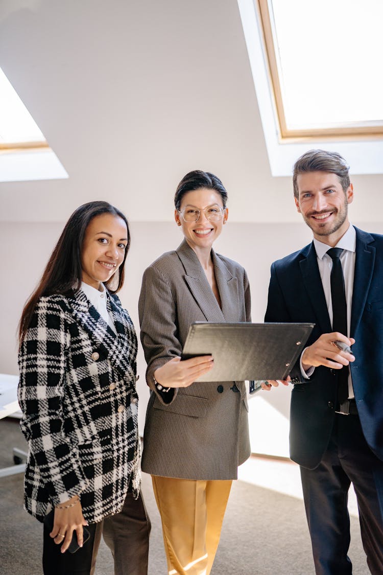 Women And Man Wearing Coats At The Office