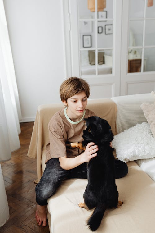 A Boy Playing with His Dog