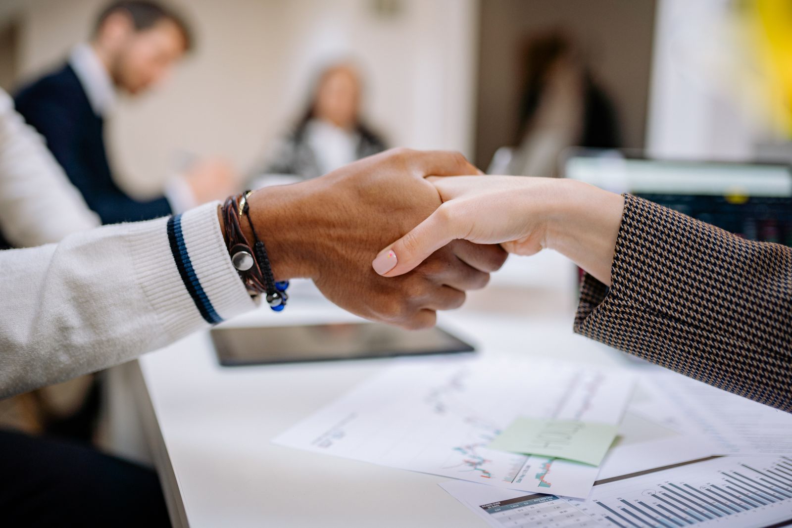 Two professionals shaking hands after a discussion