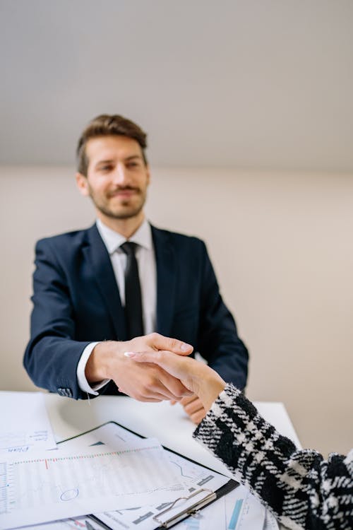 Free People Shaking Hands at an Office Stock Photo