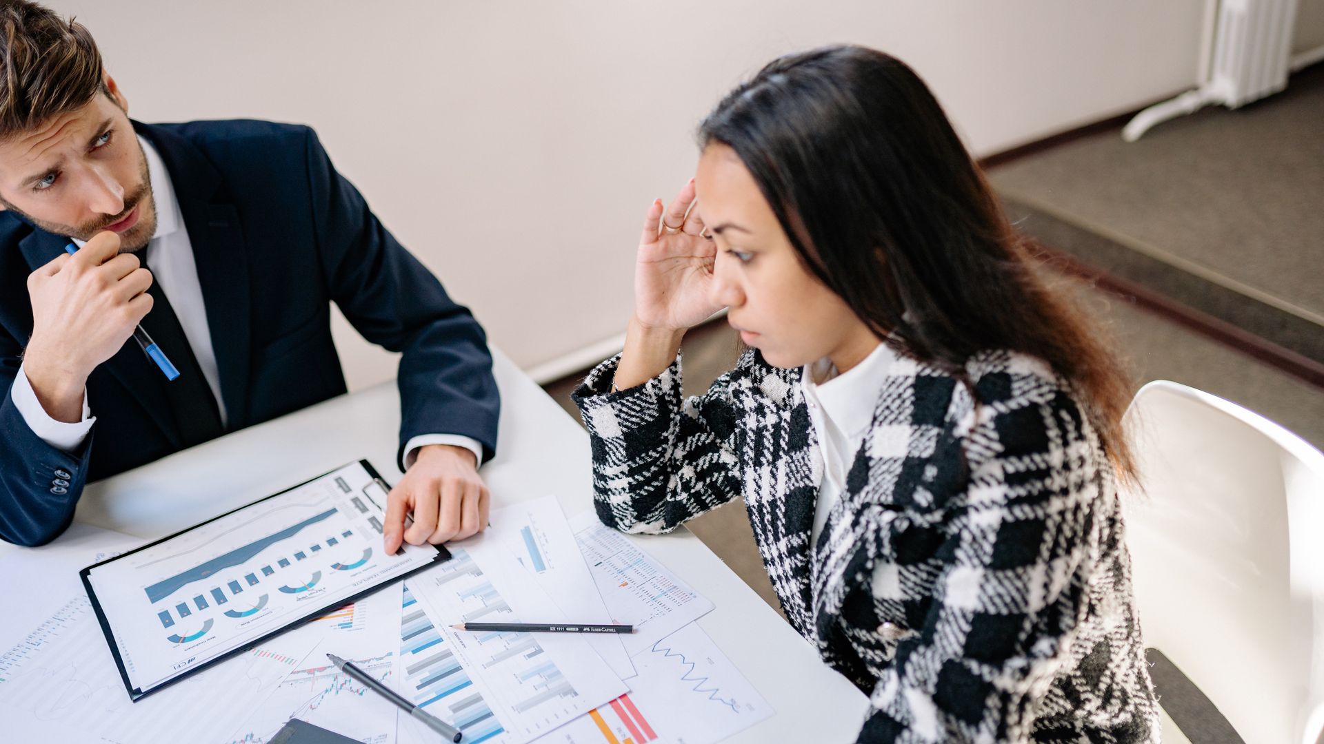 Modafinil Decision Making: A Comprehensive Guide Two colleagues discussing graphs and charts during a business meeting indoors — modafinil decision making