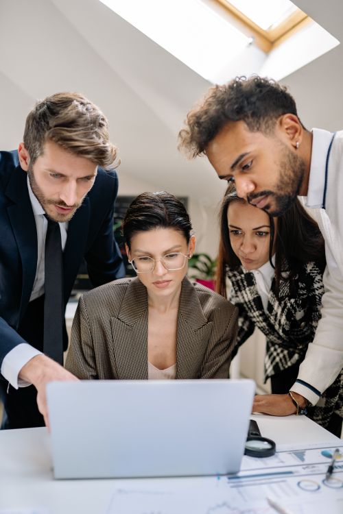 Free A group of professionals collaborating on a project in a modern office. Stock Photo