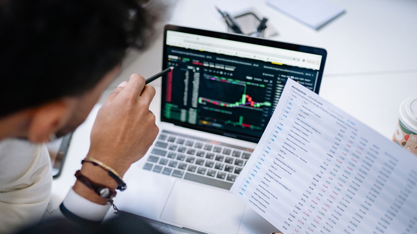 Illustration: Yan Krukau / Pexels Person pointing at a laptop screen full of data beside a printed report