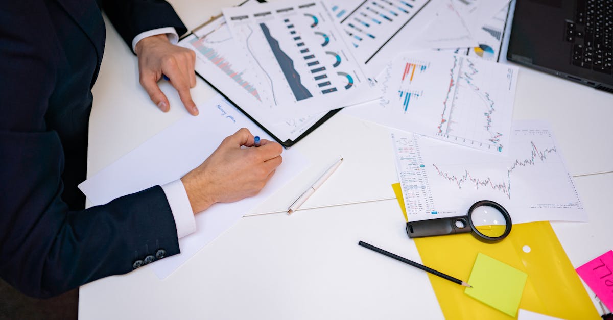 Close-up of a desk cluttered with financial charts, graphs, and reports, perfect for business and finance themes.