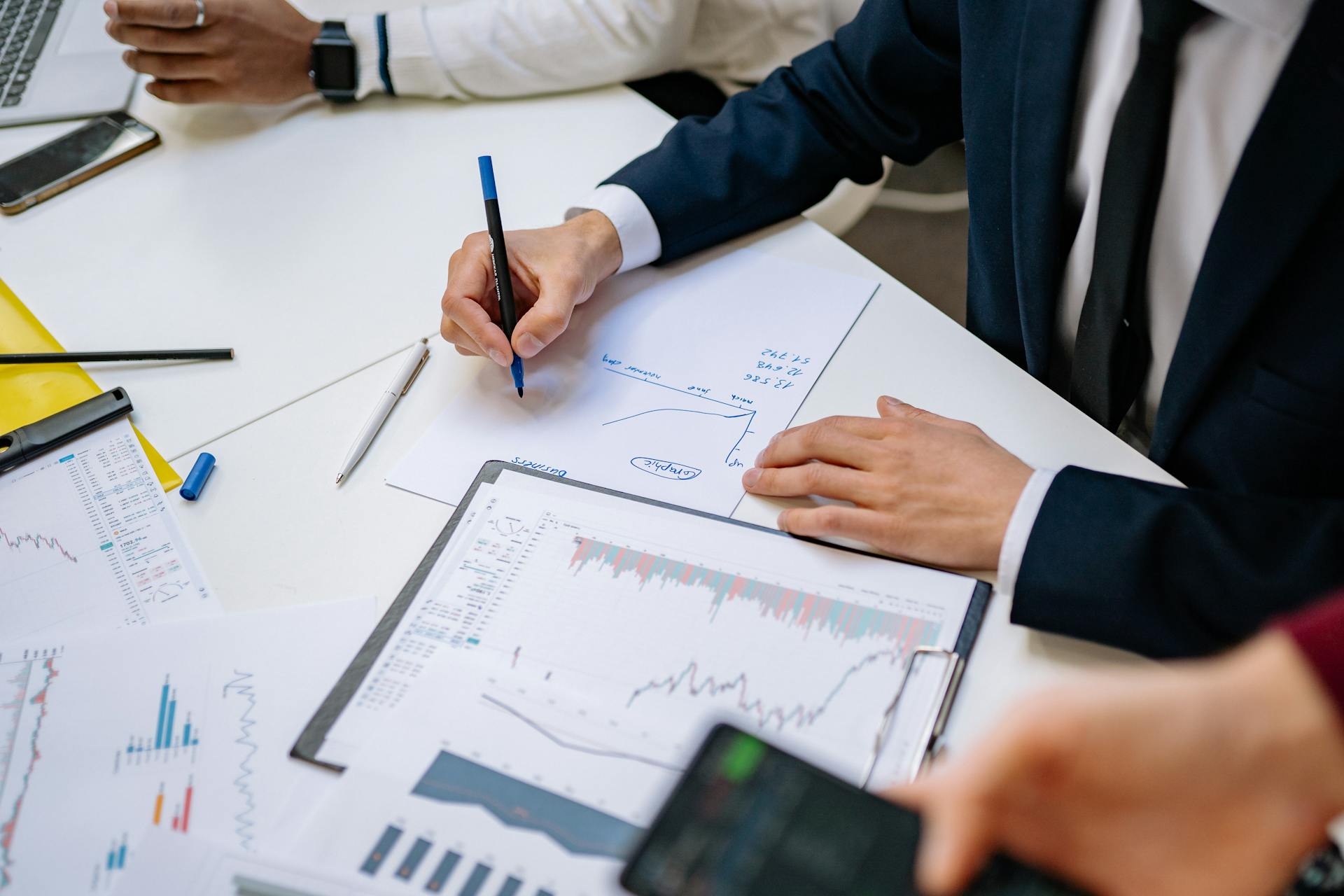 Professionals analyzing financial charts in a corporate setting.