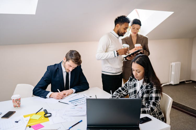 A Group Of People Busy Working Inside The Office