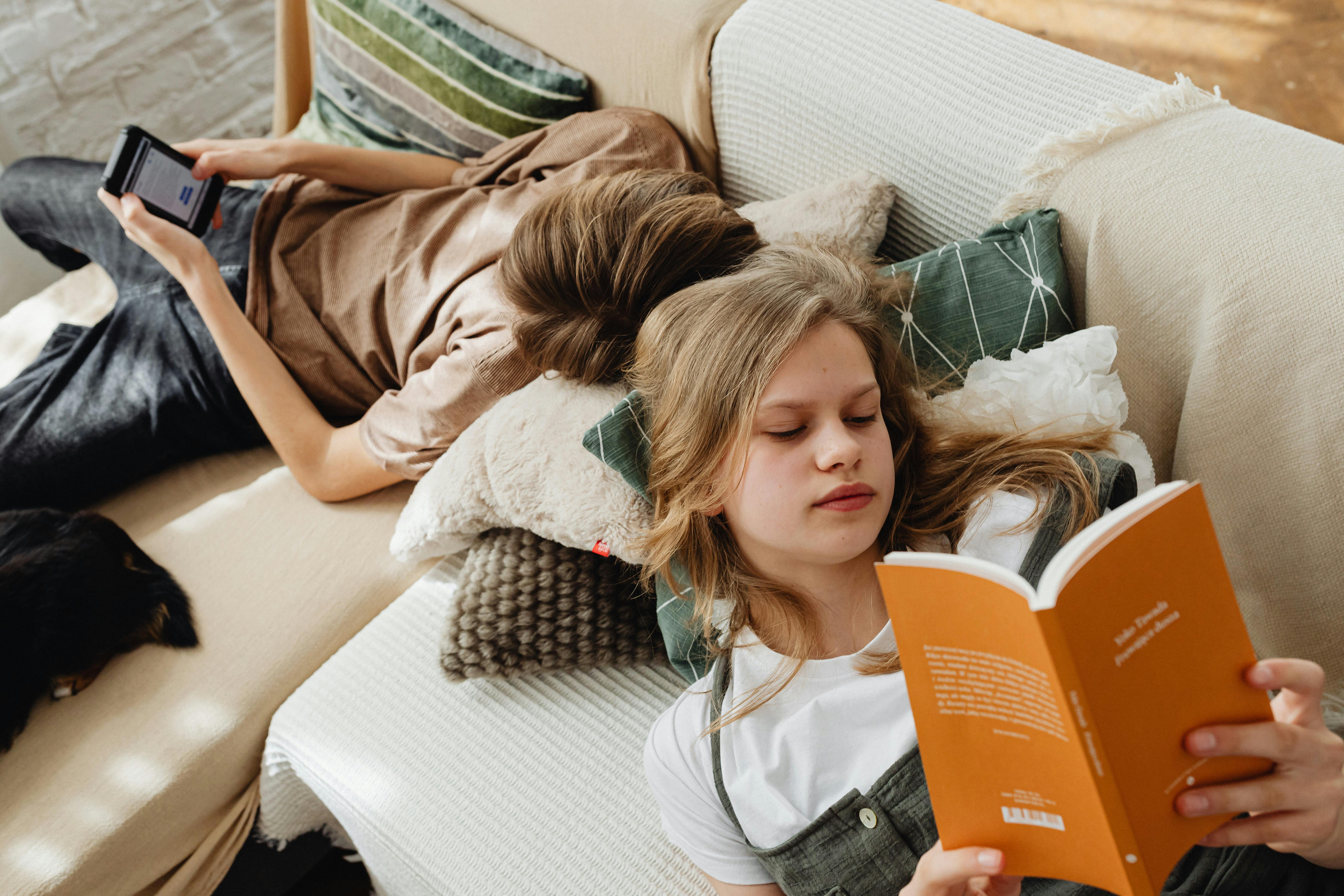 siblings lying on the couch