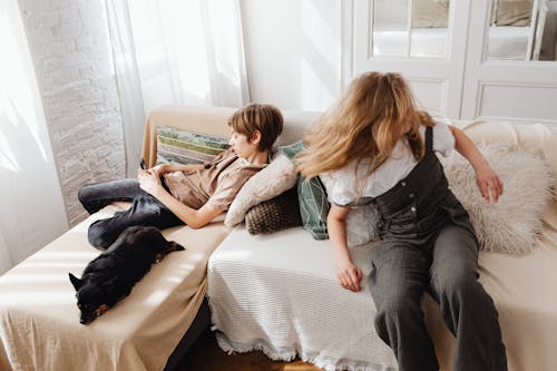 Free A Black Dog Lying Beside the Sleeping Boy  Stock Photo