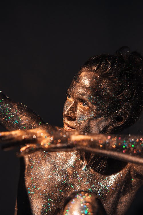 A Woman Covered with Shiny Glitters Looking Afar