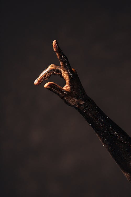 A Hand and Arm Covered with Glitters