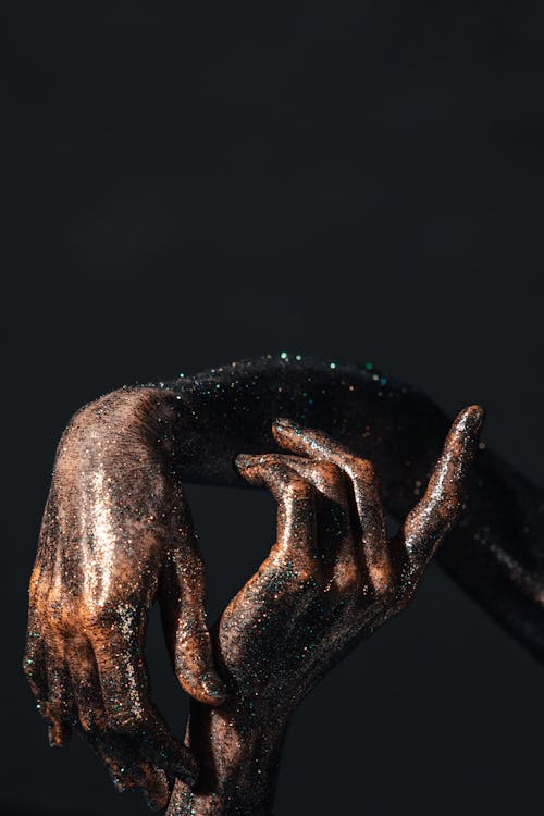 

Hands of a Person Covered with Glitters