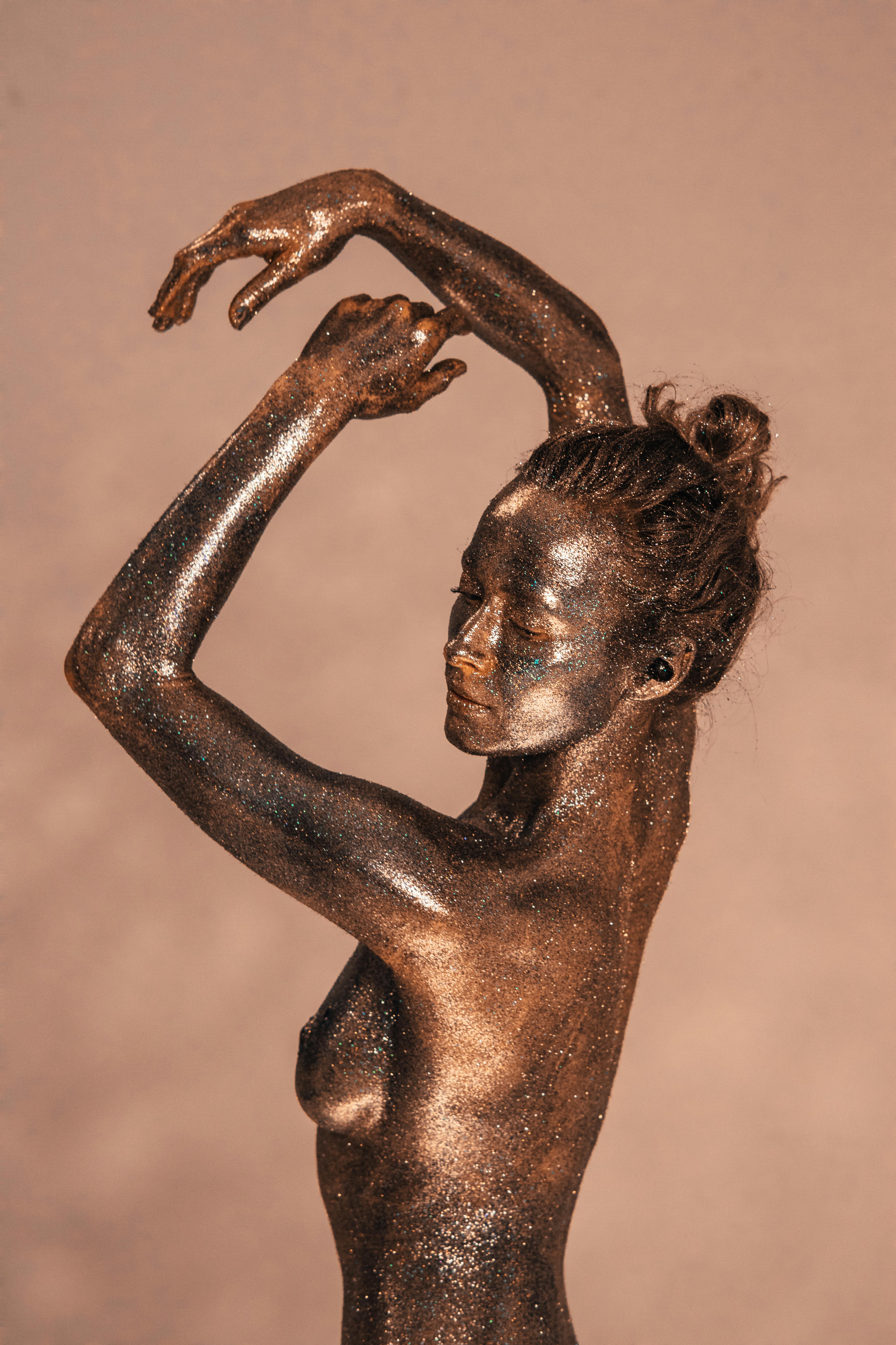 a bronze woman posing