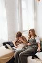 2 Women Sitting on White Couch