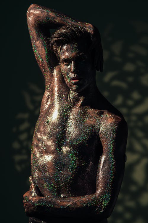 A Man Covered with Glittery Body Art Posing at the Camera