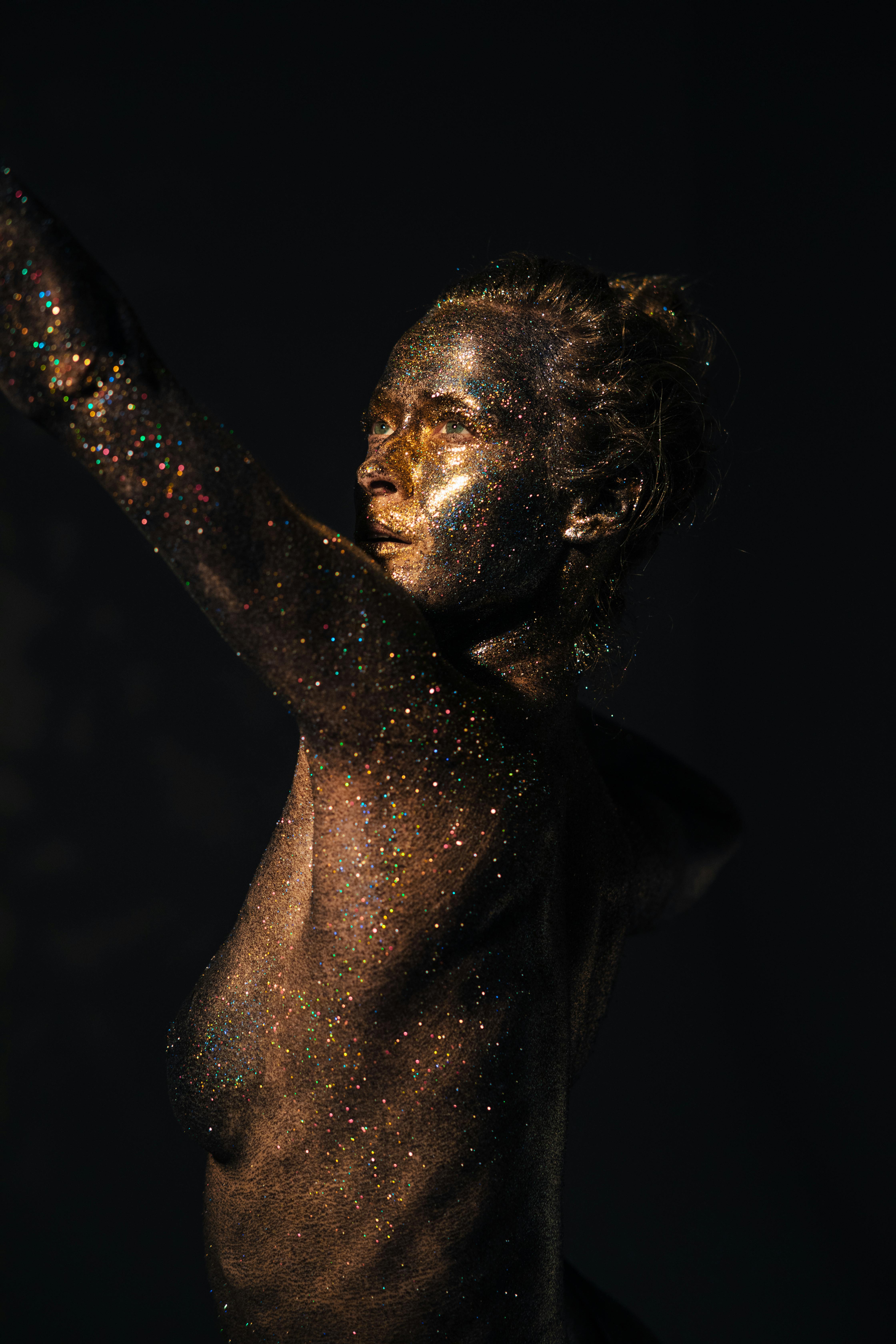a woman covered with shimmering body paint