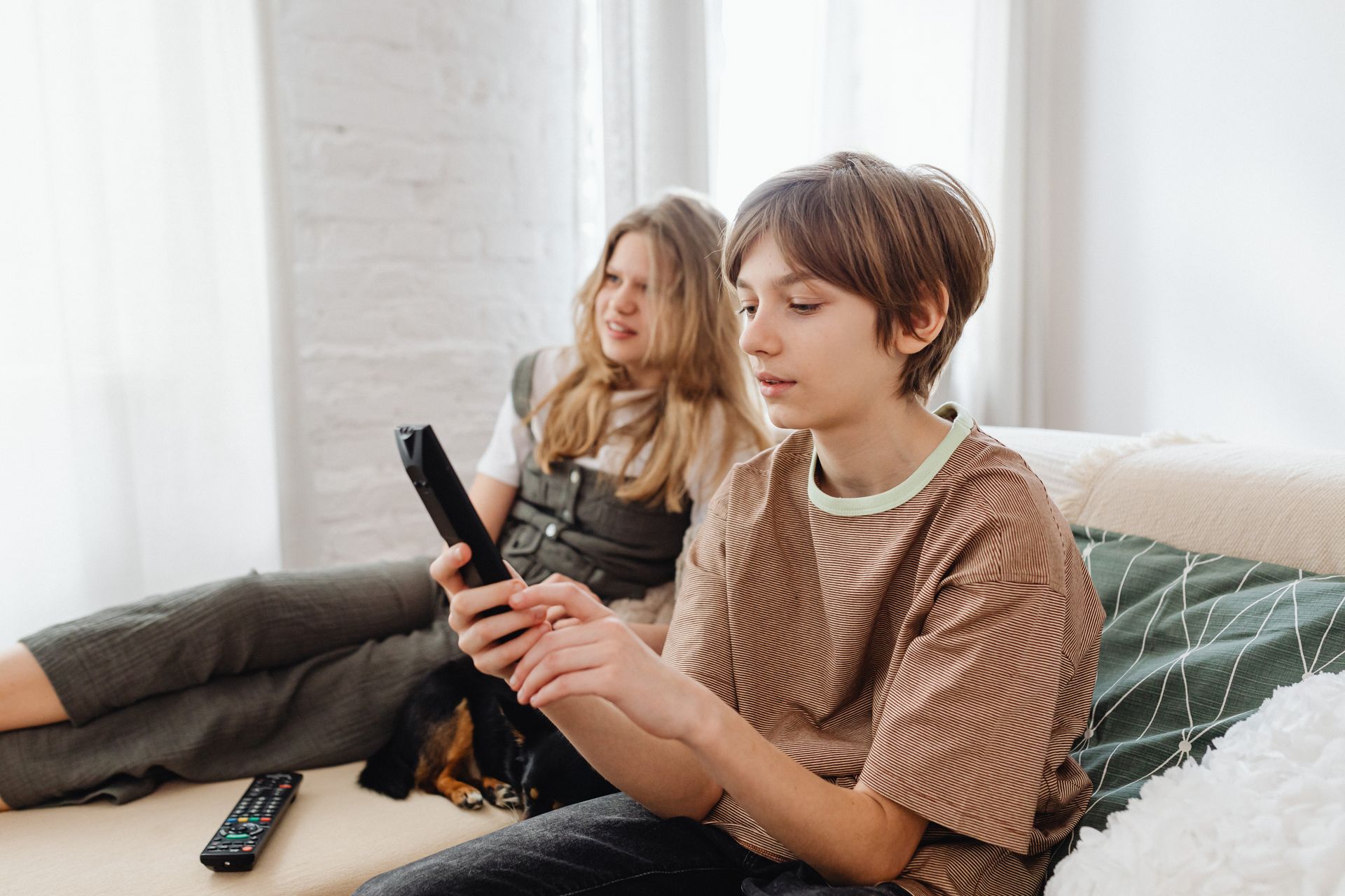 A Boy Holding a TV Remote