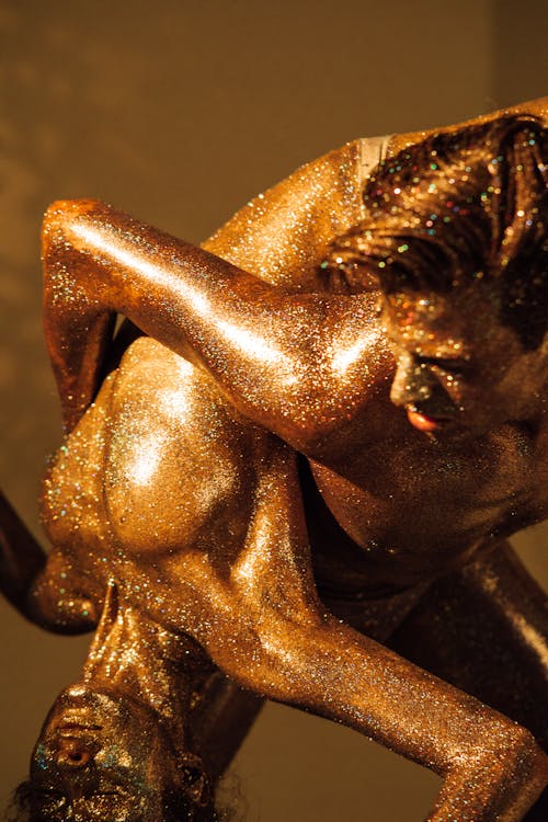 Glittery Bronze Models Posing as Statues