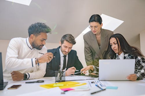 A Group of People Holding Pens Working Together  