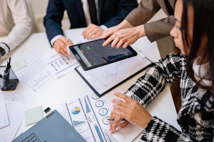 A Businesswoman Looking At Data On An IPad Screen