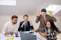 A Group of Happy People Looking at a Laptop