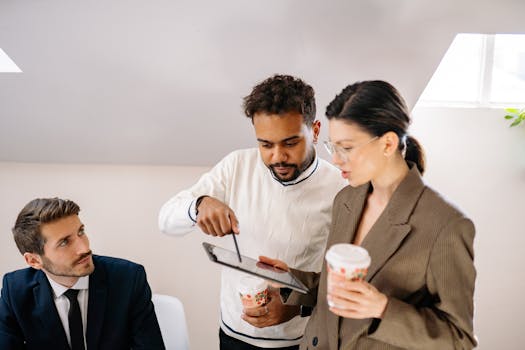 Group of professionals reviewing content on a tablet during a business meeting.