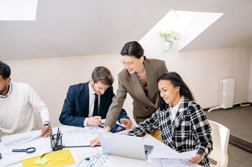 Colleagues collaborating around a laptop — Yan Krukau on Pexels