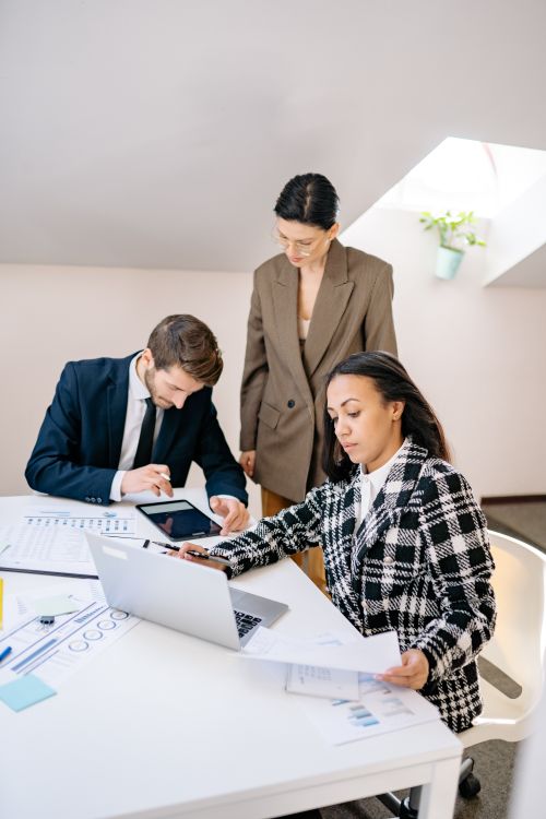 Free A diverse group of professionals working together in a bright, modern office setting. Stock Photo