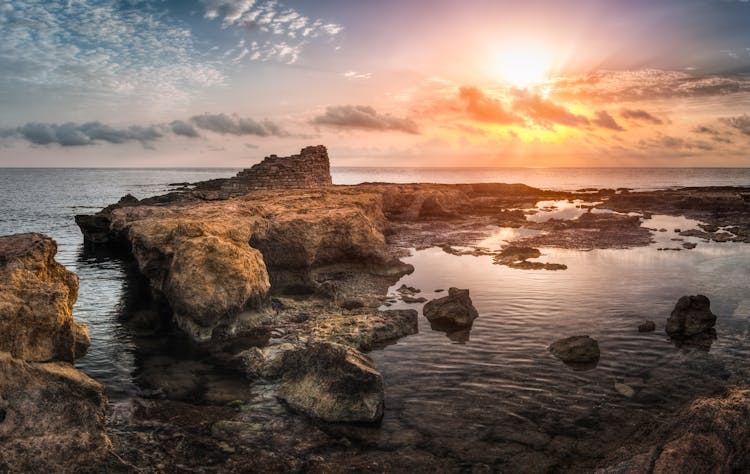 Rocks Formation On The Beach During Sunset