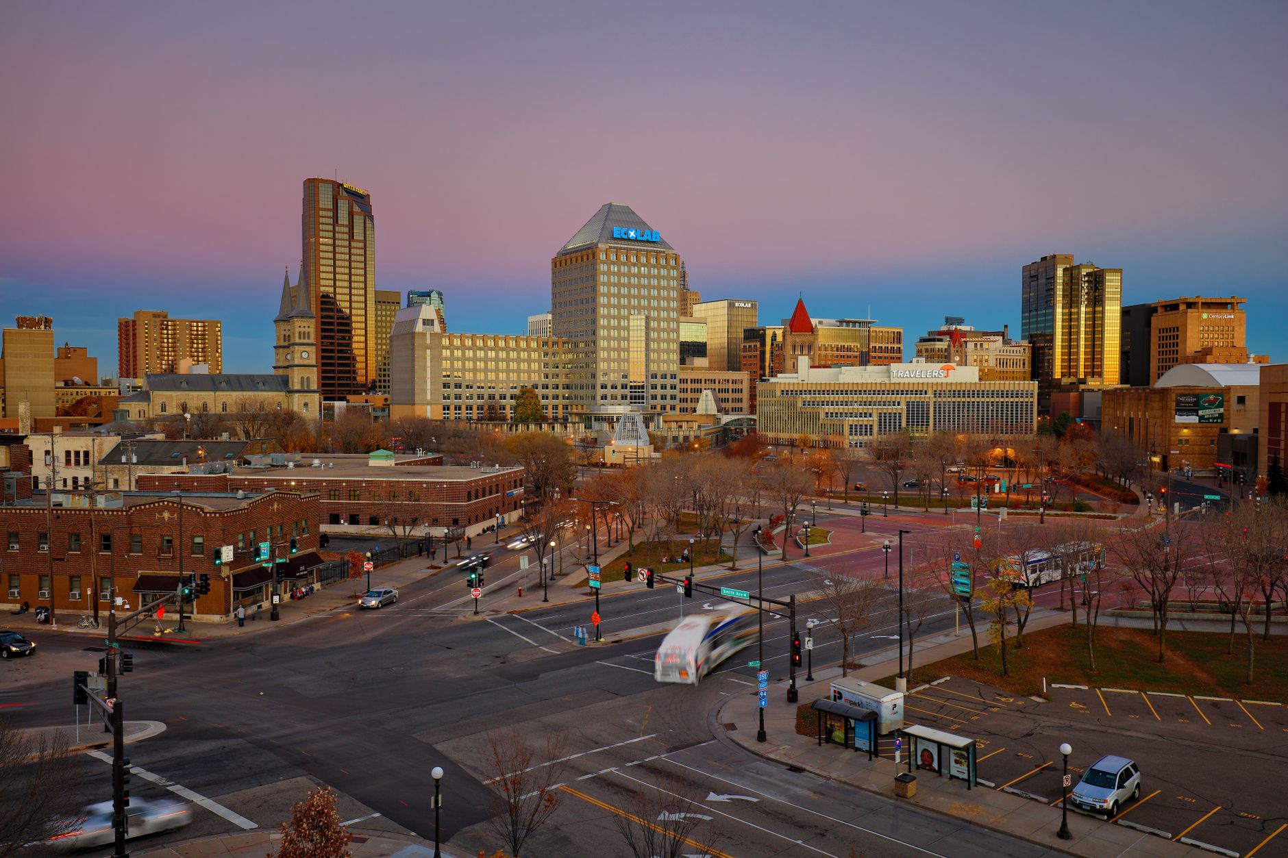 Beautiful dusk view of Saint Paul's skyline with vibrant city lights and traffic.