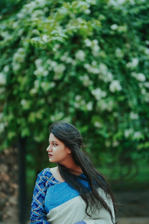 A Woman in Blue and White Saree