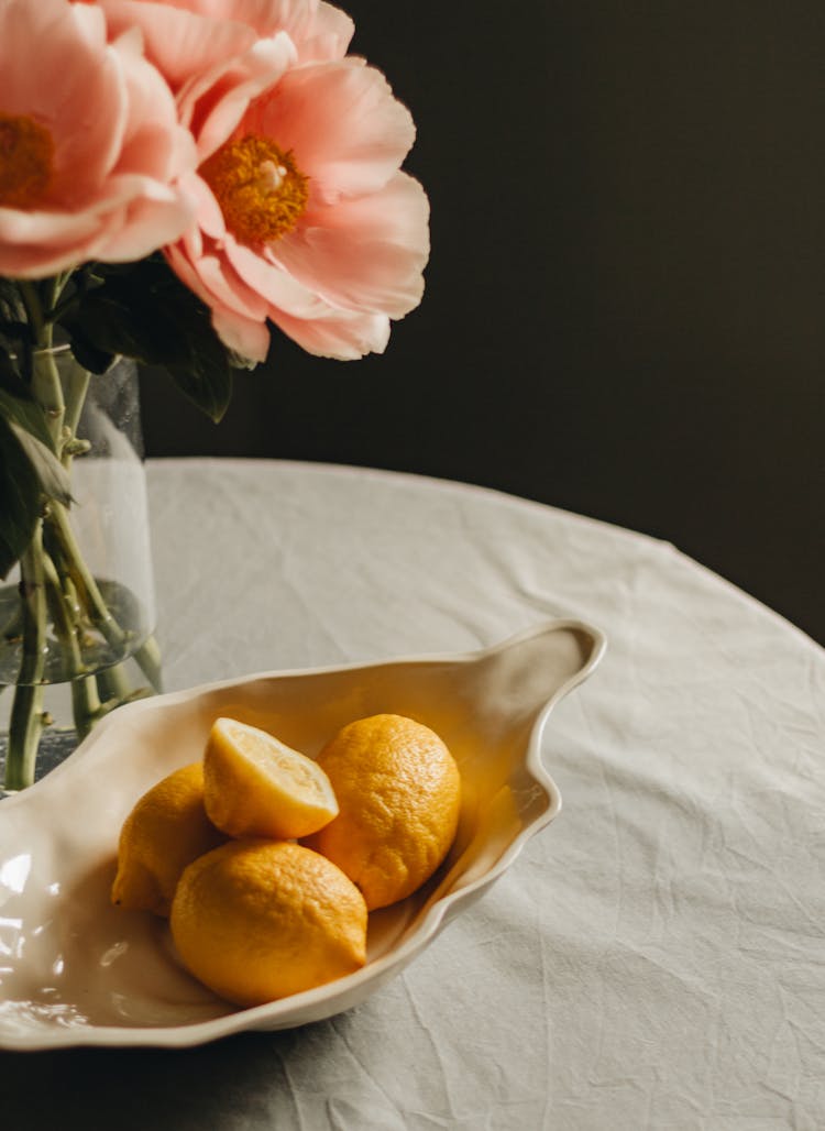 Lemons Near Blooming Pink Peonies