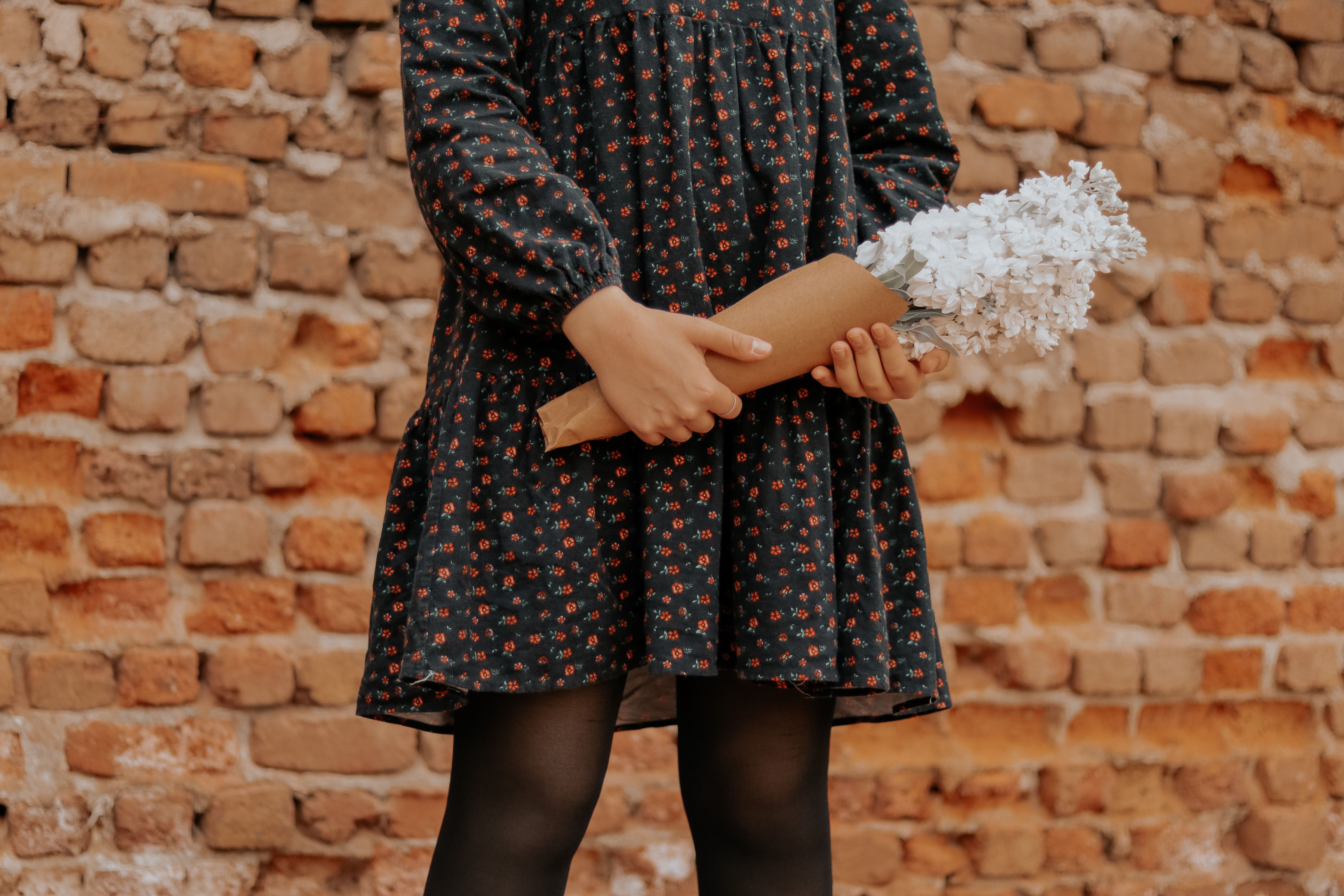 Woman in Floral Dress Holding a Bunch of Flowers · Free Stock Photo