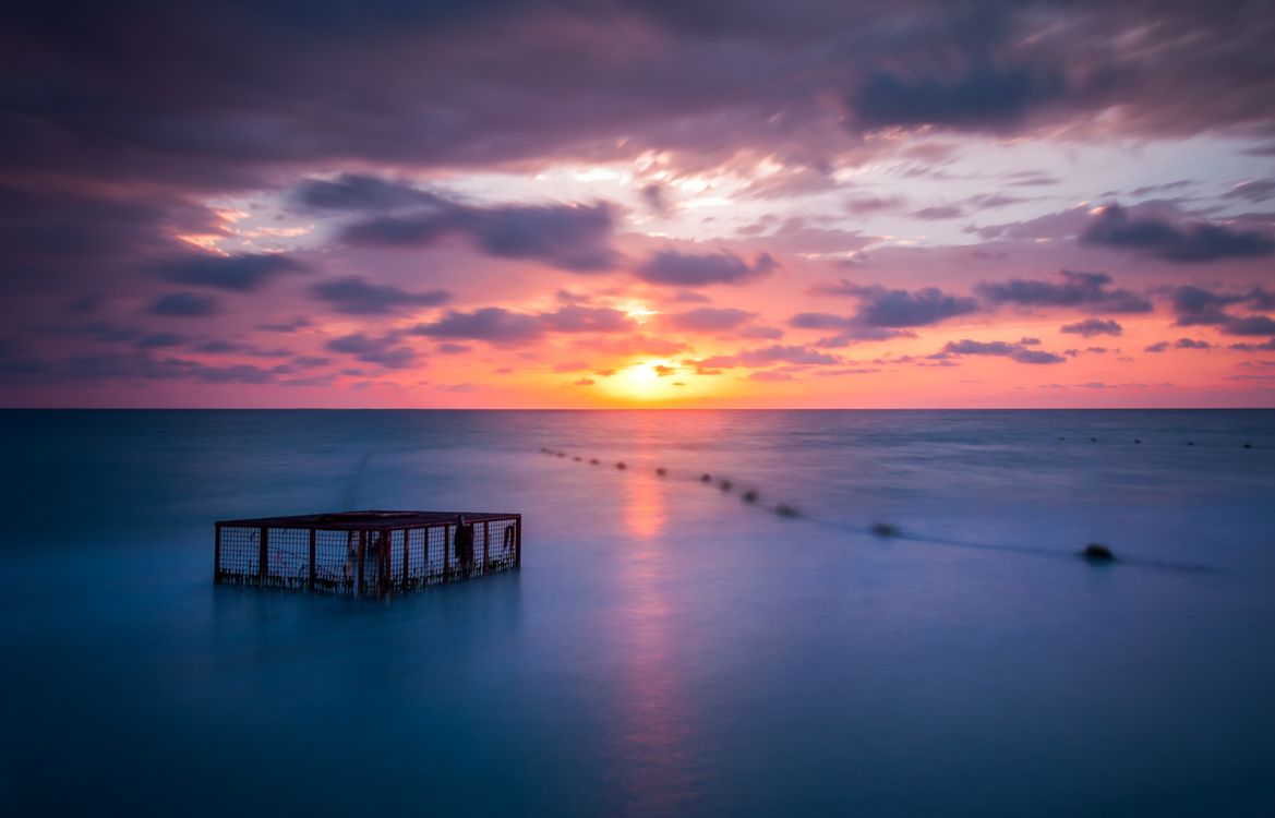 A Golden Sun Setting Over The Horizon Free Stock Photo a-golden-sun-setting-over-the-horizon-free-stock-photo