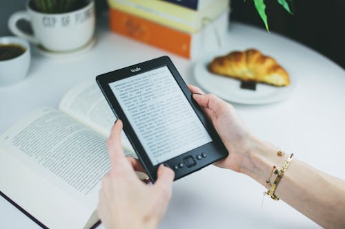 Free Person Holding Kindle E-book Reader Stock Photo