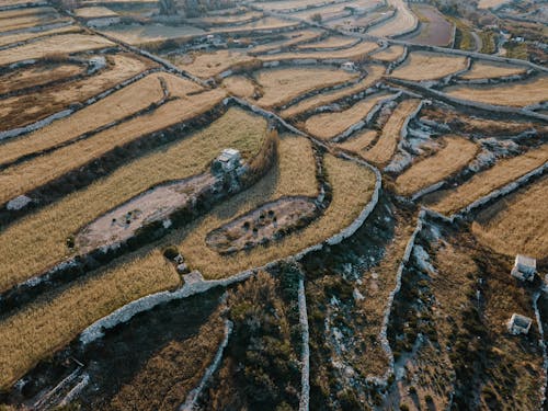 Aerial View of a Brown Terraced  Field in Wied Il-Ghajn, Malta