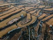 Aerial View of a Brown Terraced  Field in Wied Il-Ghajn, Malta