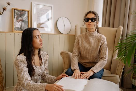Woman in Brown Sweater Sitting Beside Woman in White Sweater