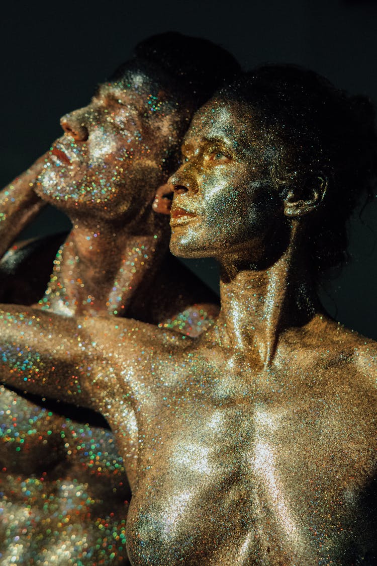 Topless Woman Covered In Glitters Holding Man's Face