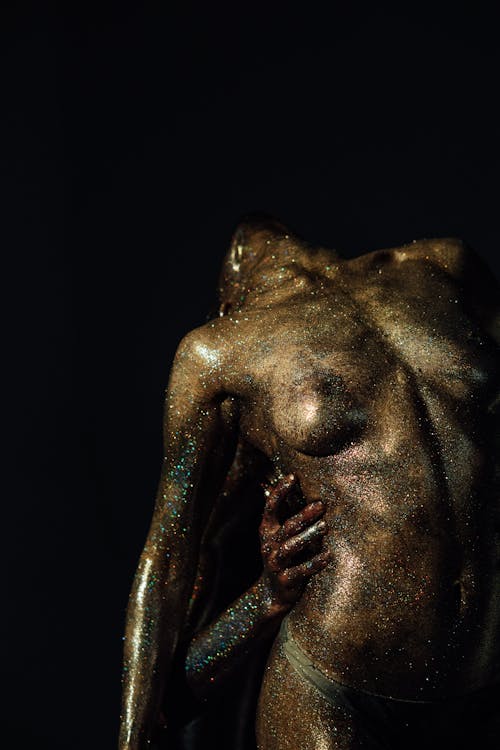 Close-Up Shot of a Woman with Glitter Makeup on Black Background