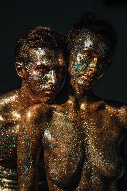 A Couple with Glittery Body Paint Posing Together
